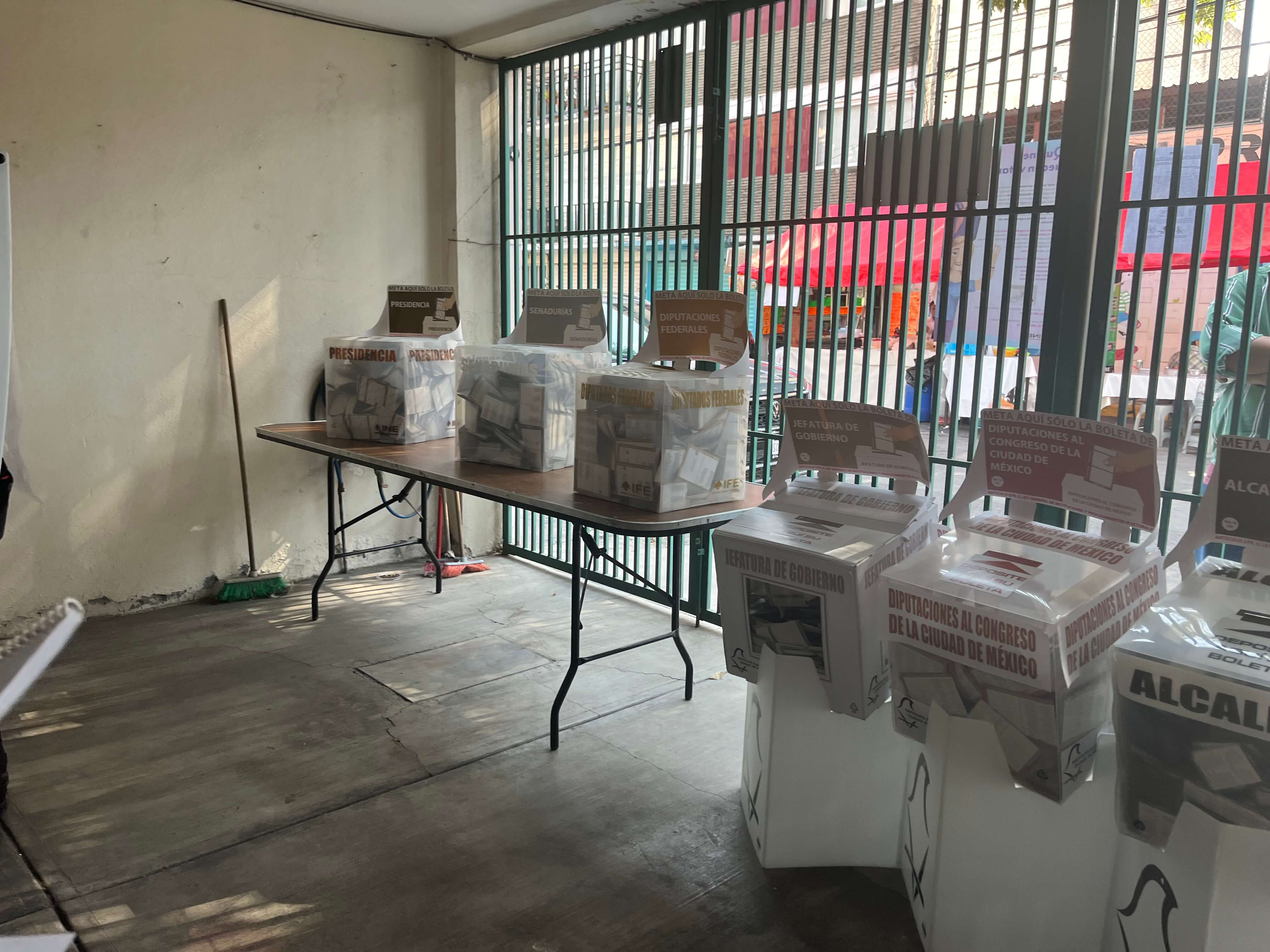 Six urnes dans un lieu de vote établi dans une maison au Mexique.